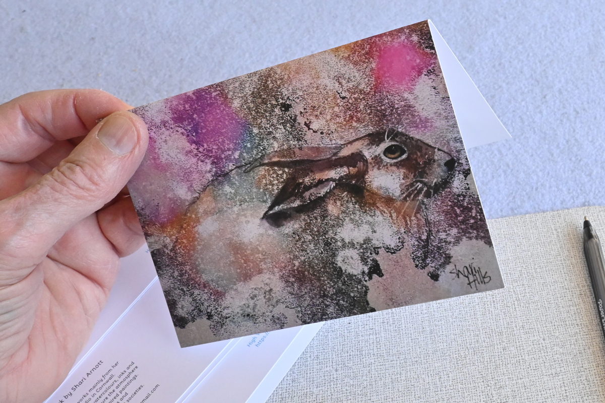 A Shari A6 card held in the hand for display